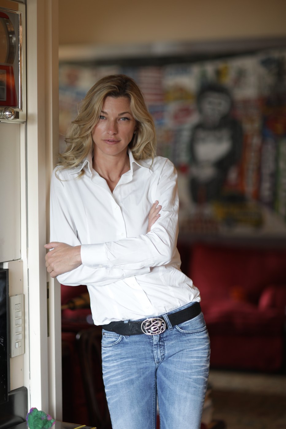 Nicole Junkermann standing in a doorway in a bright home interior, a relaxed portrait