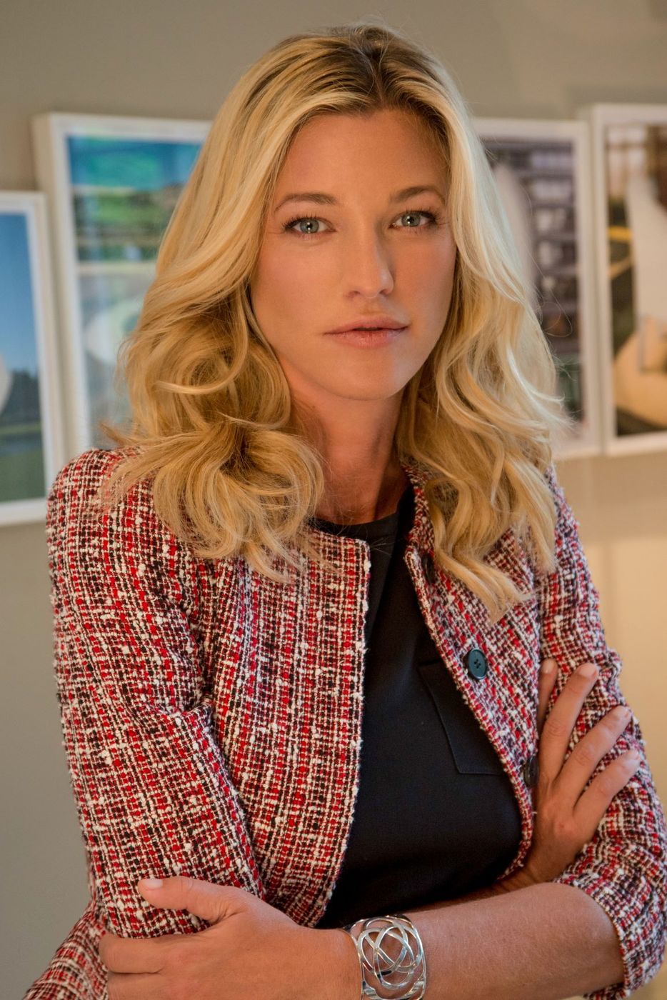 Portrait of Nicole Junkermann with blond hair, in a tweed jacket, looking calmly at the camera in a bright room